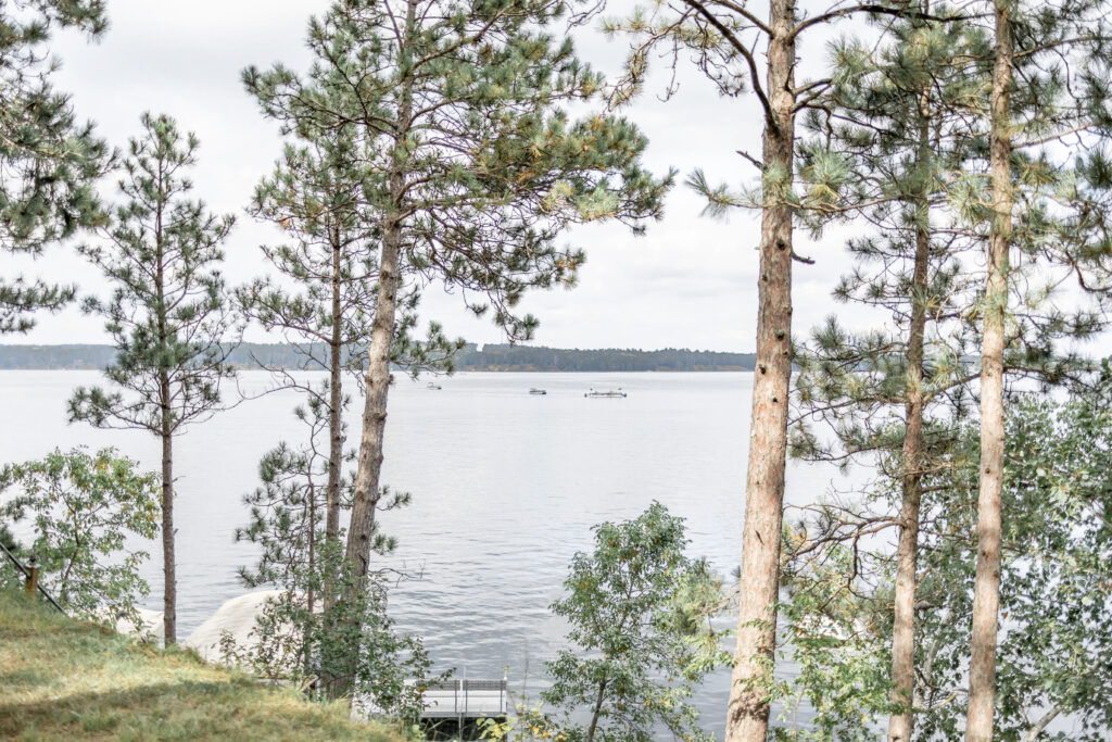 Pontoons on the lake await the guests after the portraits are taken by the Brainerd wedding photographer