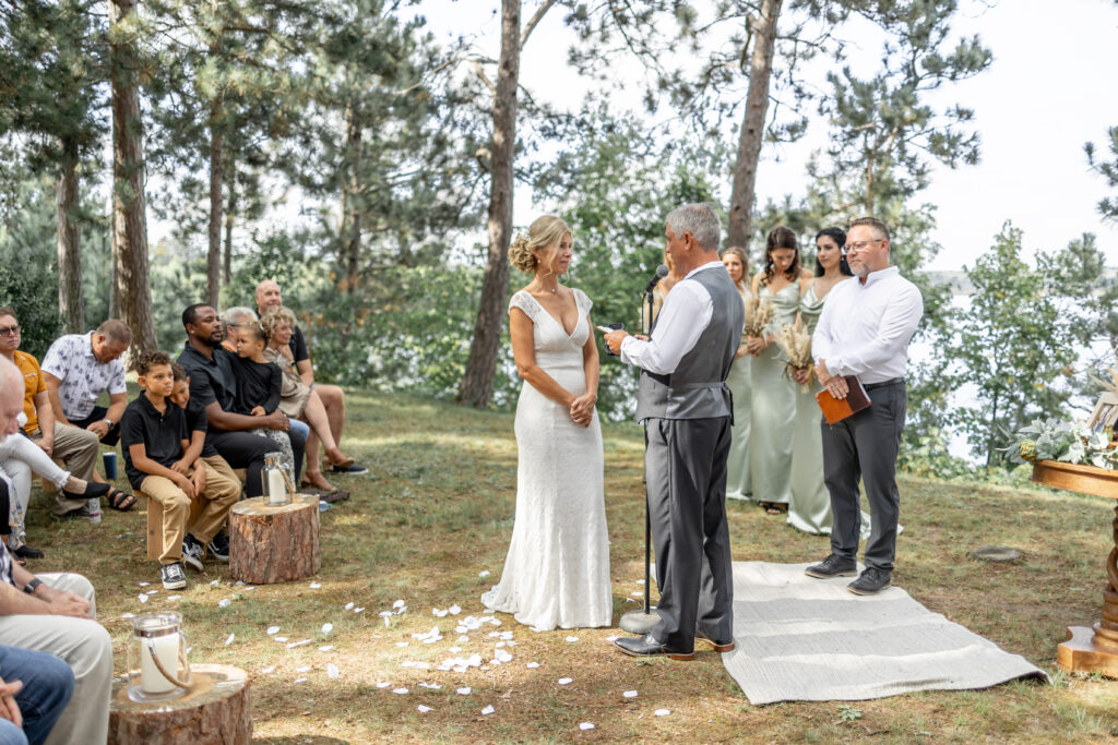The bride and groom crying as they say their vows and are photographed by the Brainerd wedding photographer